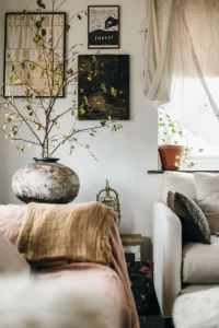 Living room corner with sofas, pictures and vase